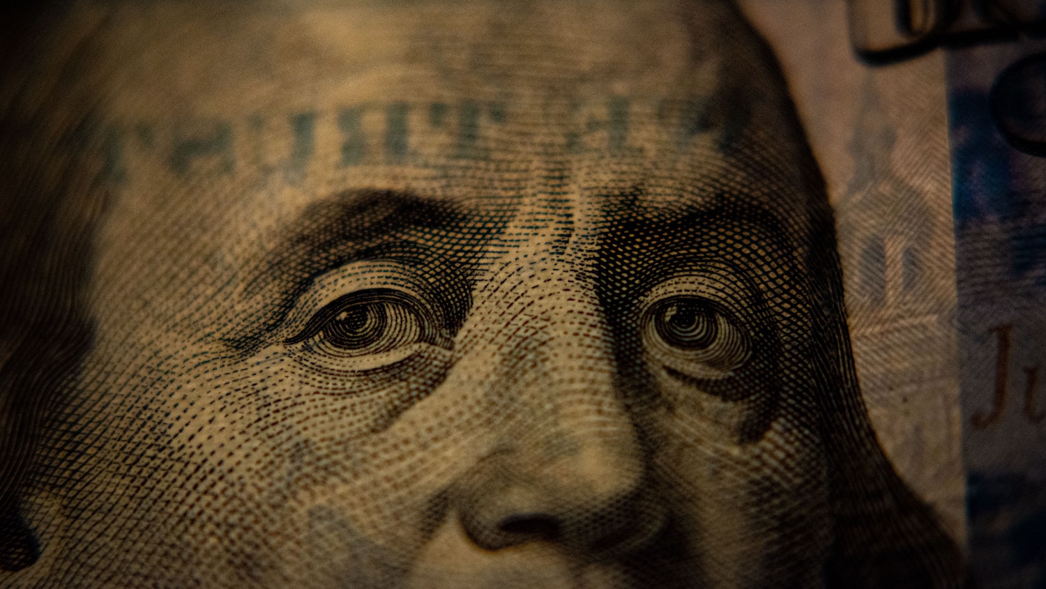 A closeup of a U.S. hundred-dollar bill (Benjamin Franklin side).