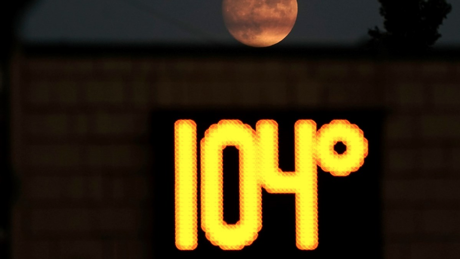 temperature gauge showing 104 degrees as moon rises