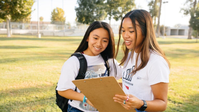 Two girls with clipboard|Two girls with clipboard