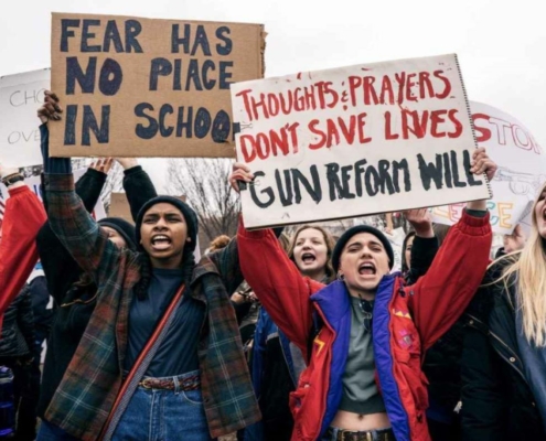students holding signs promoting gun reform