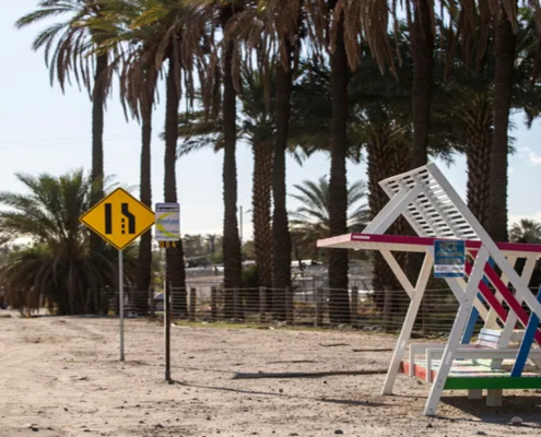 A shade structure is built around a bus stop