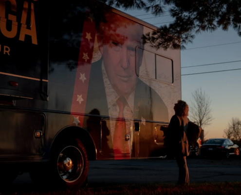 Woman in front of Trump campaign truck