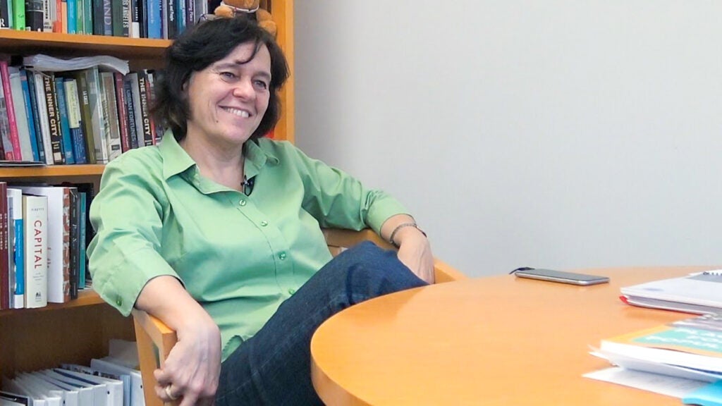 professor seated at a table in her office