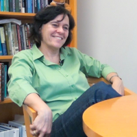 professor seated at a table in her office