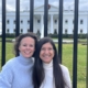 Two women in front of White House fence