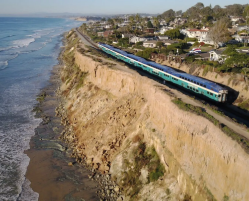 train along oceanside cliff