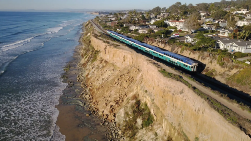 train along oceanside cliff