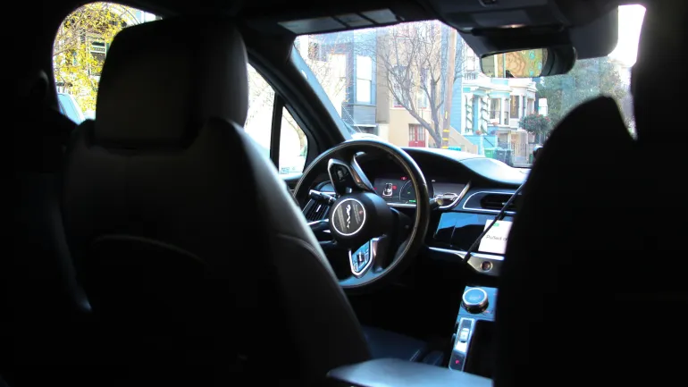 view from back seat of a steering wheel in a driverless vehicle