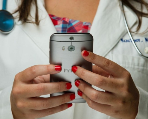 Doctor's hands holding mobile phone