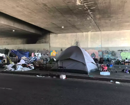 tents housing homeless in road tunnel