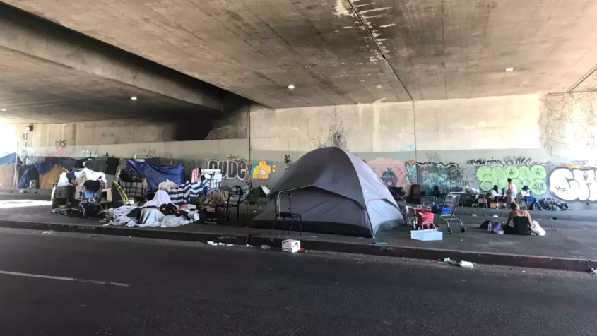 tents housing homeless in road tunnel