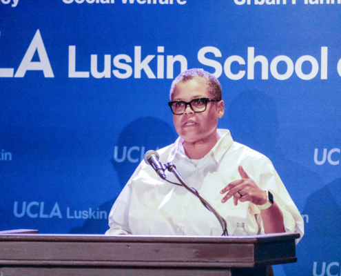woman with glasses and white shirt at podium