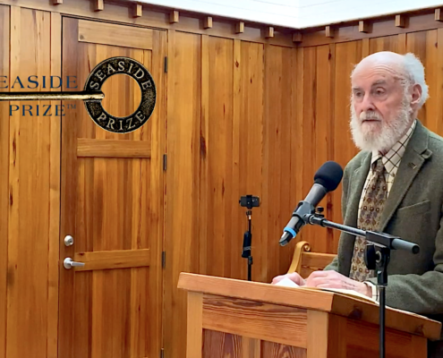 man with gray hair and beard at podium