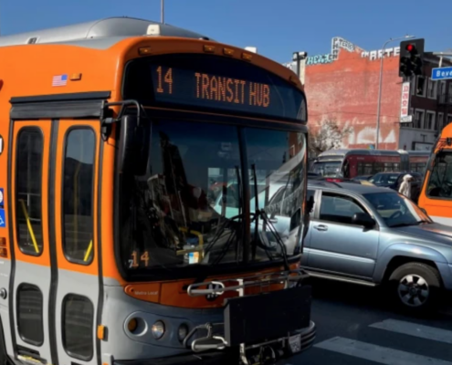 orange bus on city street