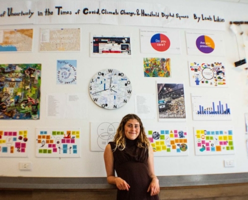 Young woman in front of art display