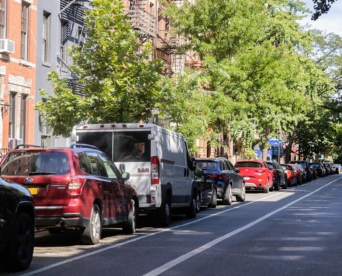 cars parked curbside on city street