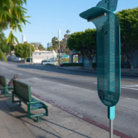 metal device attached to pole on city sidewalk