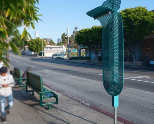 metal device attached to pole on city sidewalk