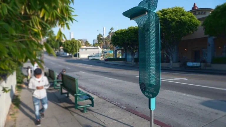 metal device attached to pole on city sidewalk