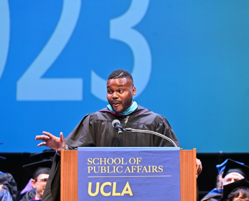 man in academic regalia at podium