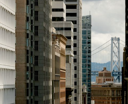 bridge seen through rows of skyscrapers