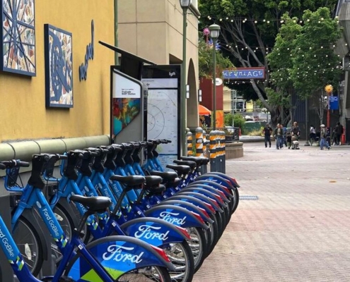 line of blue bicycles for rent