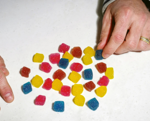 multi-colored chewables on a white surface