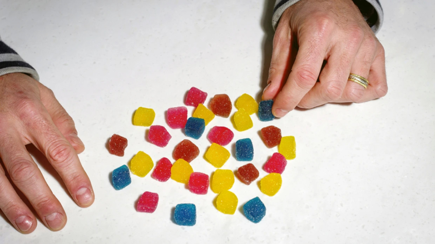 multi-colored chewables on a white surface