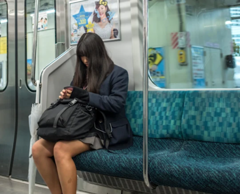 young woman sitting alone on subway