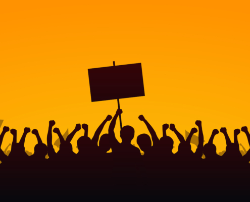Silhouette group of people Raised Fist and Protest Signs in yellow evening sky background