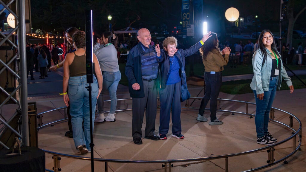 People standing in circle on outdoor stage