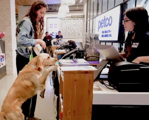 Pet owner and dog at pet store counter