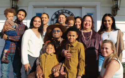 many generations of a Latino family pose for a photo
