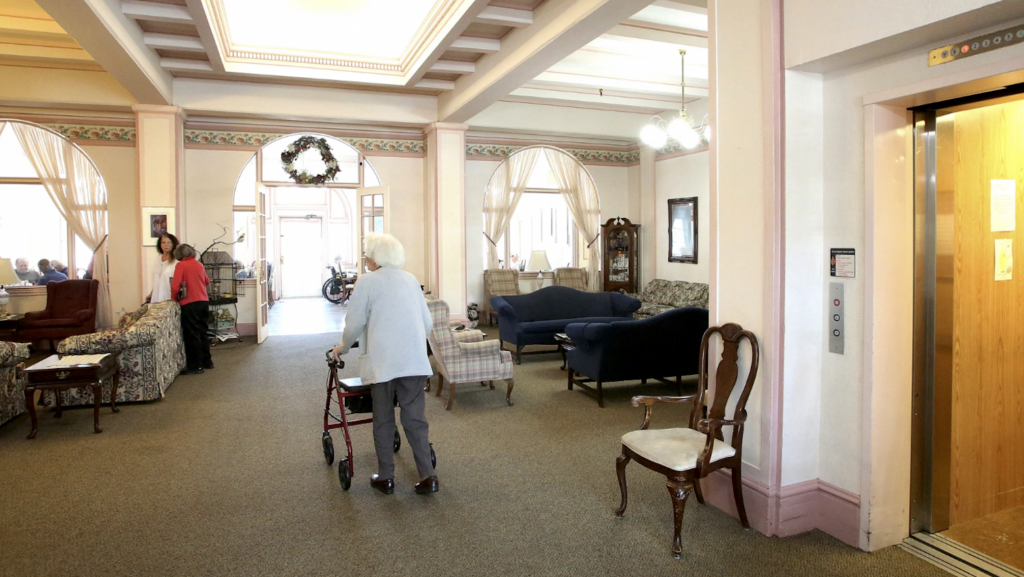 woman with a walker in a lobby