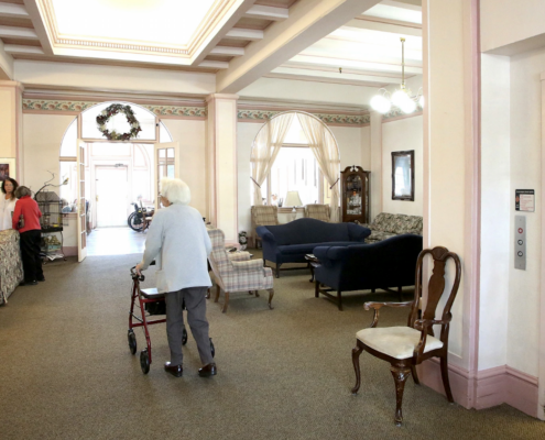woman with a walker in a lobby