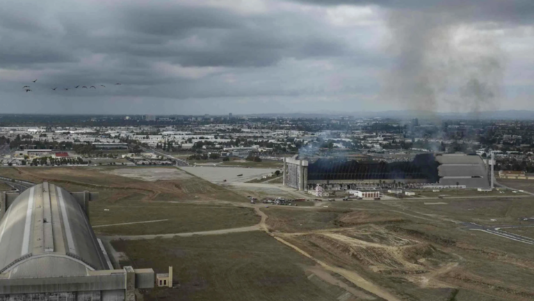 smoke emerging from fire-damaged structure