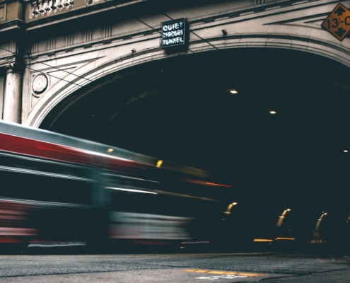 timelapse photo of bus entering tunnel
