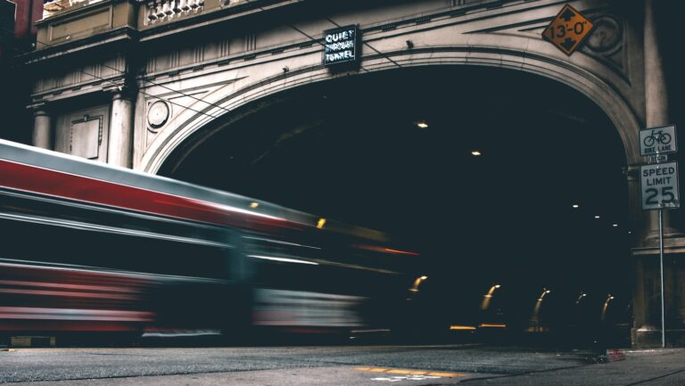 timelapse photo of bus entering tunnel