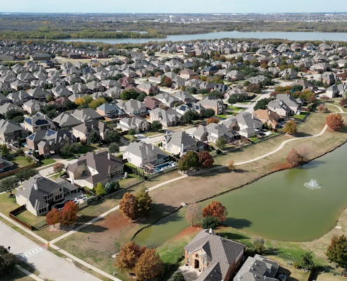 overhead shot of housing development near manmade lakes