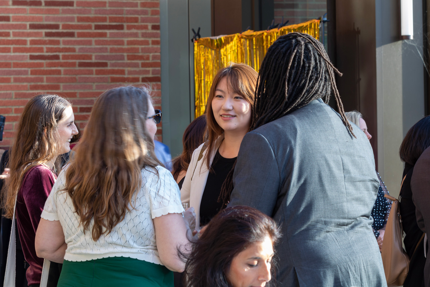 a group of women chat during an event at UCLA