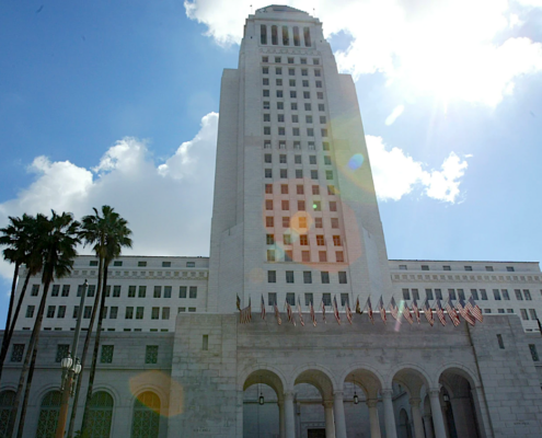 Tall white building set against blue sky