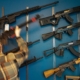 man facing wall lined with firearms for sale