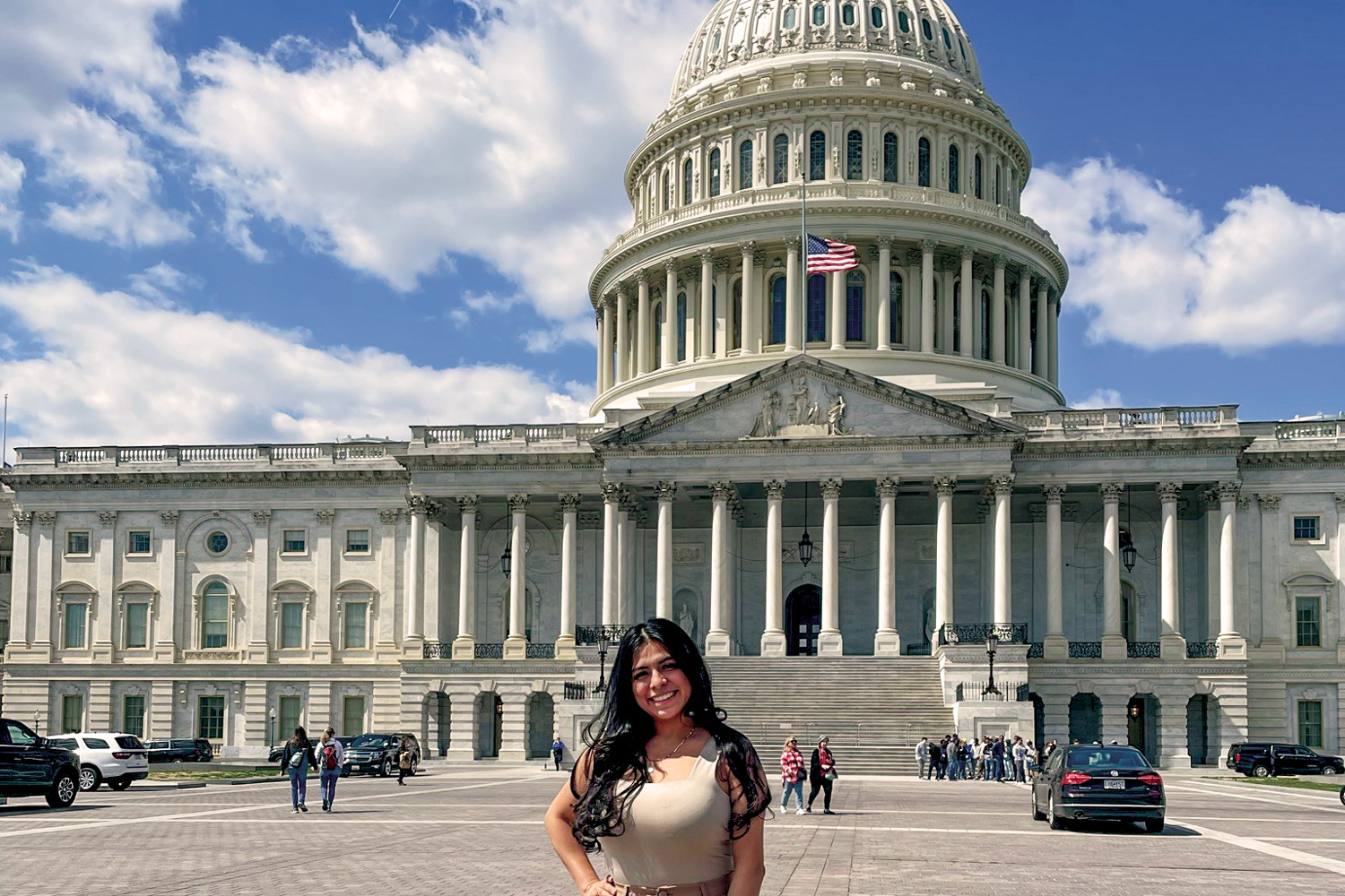 Young woman stands in front of the U.S. Capitol.