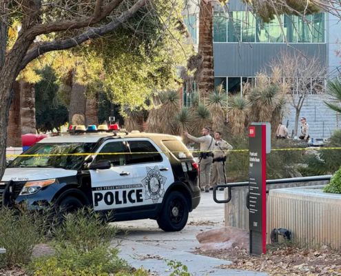 police car and officers in front of building