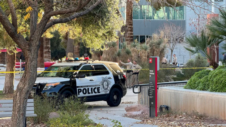 police car and officers in front of building
