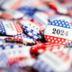 red, white and blue election buttons emblazoned with "2024"
