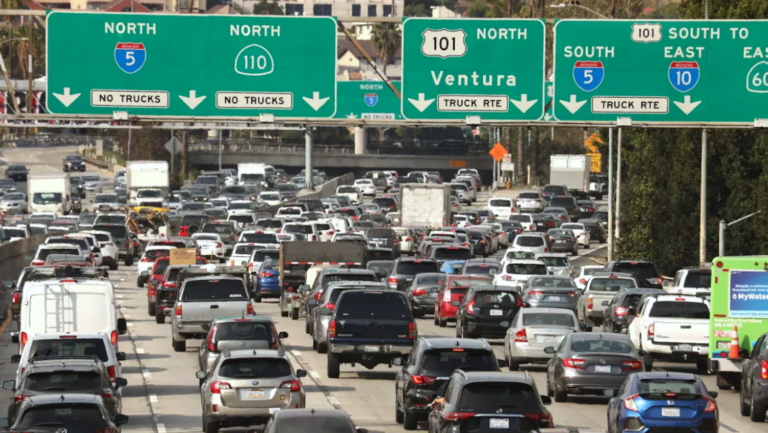 heavy traffic under freeway signs