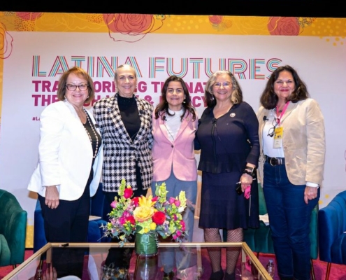 Five women standing in from of sign saying "Latina Futures"