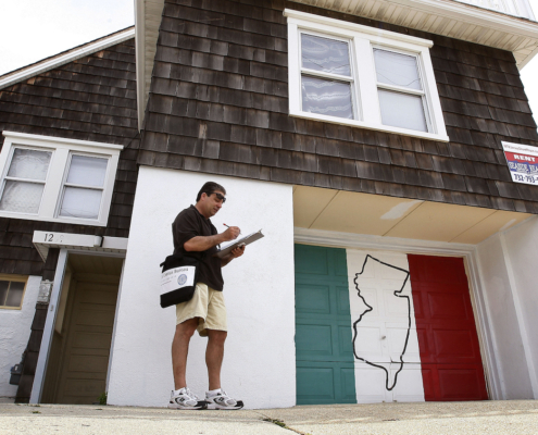 Census worker in front of house