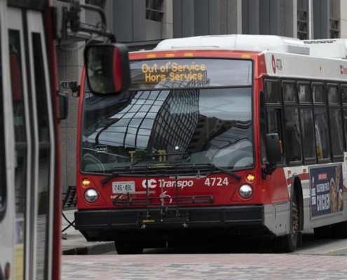 red and white bus with "Out of Service" sign